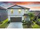 Charming two-story home featuring a spacious two-car garage, landscaped front yard and inviting curb appeal at 582 Royal Empress Dr, Ruskin, FL 33570