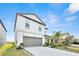 Two-story home featuring a neutral color palette, attached garage, and well-manicured landscaping at 582 Royal Empress Dr, Ruskin, FL 33570