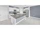 Modern kitchen featuring white cabinets, granite countertops, and stainless steel appliances at 582 Royal Empress Dr, Ruskin, FL 33570