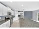 Spacious kitchen with white cabinets, granite countertops, stainless steel appliances, and a large island at 582 Royal Empress Dr, Ruskin, FL 33570