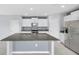Modern kitchen featuring granite countertops, white cabinets, and stainless steel appliances at 582 Royal Empress Dr, Ruskin, FL 33570