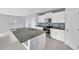 Modern kitchen featuring granite countertops, stainless steel appliances, and white cabinets at 582 Royal Empress Dr, Ruskin, FL 33570