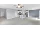 Open-concept space with white cabinets, stainless appliances, granite countertops, and gray tile flooring at 582 Royal Empress Dr, Ruskin, FL 33570