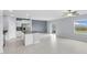 Modern kitchen island featuring granite countertops, stainless appliances, and gray tile flooring at 582 Royal Empress Dr, Ruskin, FL 33570