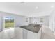 Large kitchen island featuring granite countertops and double sink in a bright open-concept space at 582 Royal Empress Dr, Ruskin, FL 33570