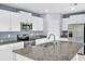 Modern kitchen featuring white cabinets, granite countertops, and stainless steel appliances at 582 Royal Empress Dr, Ruskin, FL 33570