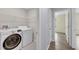 Laundry room with side-by-side washer and dryer and wire rack shelving at 582 Royal Empress Dr, Ruskin, FL 33570
