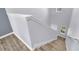 A view of wooden stairs with white railing and trim, and the upstairs hallway with high ceilings at 582 Royal Empress Dr, Ruskin, FL 33570