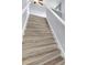 A staircase featuring light wood steps, white risers and white railings ascend to the second floor at 582 Royal Empress Dr, Ruskin, FL 33570