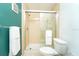 Small bathroom featuring a glass shower enclosure with white and beige tiling at 6006 Laketree Ln # K, Temple Terrace, FL 33617