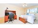 Bright bedroom features neutral walls, large window, ceiling fan, desk and workstation at 6006 Laketree Ln # K, Temple Terrace, FL 33617