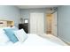 Cozy bedroom with blue accent pillows, closet, and dresser providing ample storage at 6006 Laketree Ln # K, Temple Terrace, FL 33617