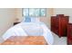 Bright bedroom features neutral walls, large window, and wood furniture at 6006 Laketree Ln # K, Temple Terrace, FL 33617
