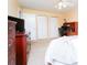 View of the bedroom with closet, dresser and desk, all in a neutral color palette at 6006 Laketree Ln # K, Temple Terrace, FL 33617