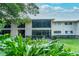 Well-maintained condo building with lush landscaping and large windows for natural light at 6006 Laketree Ln # K, Temple Terrace, FL 33617