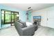 Spacious living room with sliding glass doors leading to an enclosed porch at 6006 Laketree Ln # K, Temple Terrace, FL 33617