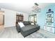 Living room with a gray sectional sofa and light blue accent wall at 6006 Laketree Ln # K, Temple Terrace, FL 33617