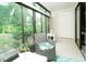 Comfortable sunroom features large windows, neutral color scheme, tile flooring and patio access at 6006 Laketree Ln # K, Temple Terrace, FL 33617