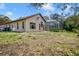 Exterior view of home with screened pool enclosure and spacious backyard at 7333 Royal Oak Dr, Spring Hill, FL 34607