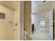 Bathroom featuring walk-in shower, floral wallpaper, and view into bedroom at 7333 Royal Oak Dr, Spring Hill, FL 34607