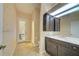 Well-lit bathroom showcasing elegant floral wallpaper, modern vanity, and a walk-in shower at 7333 Royal Oak Dr, Spring Hill, FL 34607