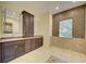 Bathroom featuring a large vanity with plenty of counter space and a mosaic tile accent wall at 7333 Royal Oak Dr, Spring Hill, FL 34607