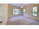 Bright bedroom features plush carpet, neutral colors, and windows with natural light at 7333 Royal Oak Dr, Spring Hill, FL 34607