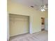 Bedroom with a ceiling fan, neutral carpet, and open closet space with wire shelving at 7333 Royal Oak Dr, Spring Hill, FL 34607