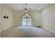 Large bedroom with large window, fan, plush carpeting, and tv mount at 7333 Royal Oak Dr, Spring Hill, FL 34607