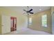 Bedroom with neutral carpet, ceiling fan, and natural light with an open doorway at 7333 Royal Oak Dr, Spring Hill, FL 34607