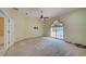 Large bedroom with large window, fan, plush carpeting, and TV mount at 7333 Royal Oak Dr, Spring Hill, FL 34607