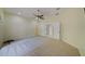 Spacious bedroom featuring a ceiling fan, plush carpeting, and double doors at 7333 Royal Oak Dr, Spring Hill, FL 34607
