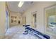 Sunlit exercise room showcasing tiled floors and gym equipment at 7333 Royal Oak Dr, Spring Hill, FL 34607