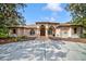 Stunning home featuring a manicured lawn, fountain, and unique architecture with arches at 7333 Royal Oak Dr, Spring Hill, FL 34607