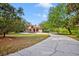 Exterior view of home with long driveway at 7333 Royal Oak Dr, Spring Hill, FL 34607