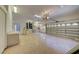 Two-car garage with ceiling fans, built-in storage cabinets, and access doors at 7333 Royal Oak Dr, Spring Hill, FL 34607