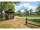 View of the community gazebo surrounded by lush landscaping and mature trees at 7333 Royal Oak Dr, Spring Hill, FL 34607