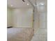 Bright hallway featuring marble floors and neutral walls leading to a large, carpeted room at 7333 Royal Oak Dr, Spring Hill, FL 34607