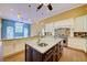 A spacious kitchen featuring an island with granite countertops, stainless steel appliances, and custom cabinetry at 7333 Royal Oak Dr, Spring Hill, FL 34607