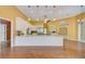 A spacious kitchen with stainless steel appliances, granite countertops, and wooden floors at 7333 Royal Oak Dr, Spring Hill, FL 34607