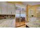 Modern kitchen with stainless steel refrigerator, custom cabinets, and granite countertops at 7333 Royal Oak Dr, Spring Hill, FL 34607
