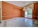 Spacious living room with elegant marble floors, decorative trim, and a large window at 7333 Royal Oak Dr, Spring Hill, FL 34607