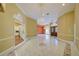 Spacious living room with marble floors, chandelier, and architectural details, and entrance to the kitchen at 7333 Royal Oak Dr, Spring Hill, FL 34607