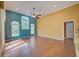 A bright and airy living room with beautiful windows, high ceilings, and warm hardwood floors at 7333 Royal Oak Dr, Spring Hill, FL 34607