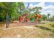 A fun playground with climbing structures, slides, and swings, all set in a shaded, natural environment at 7333 Royal Oak Dr, Spring Hill, FL 34607