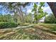 Scenic walking path alongside the tennis courts surrounded by mature trees and lush landscaping at 7333 Royal Oak Dr, Spring Hill, FL 34607