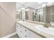Bathroom featuring a double sink vanity with tile countertops and decorative lighting at 742 45Th Ne Ave, St Petersburg, FL 33703