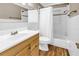 Bathroom featuring a single sink vanity, wood-look flooring, and a shower/tub combo at 742 45Th Ne Ave, St Petersburg, FL 33703