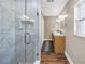 Ensuite bathroom with double vanity, updated fixtures, walk-in shower with glass doors at 742 45Th Ne Ave, St Petersburg, FL 33703