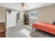 Bedroom with a single bed, carpet flooring, and a sliding barn door to the bathroom at 742 45Th Ne Ave, St Petersburg, FL 33703